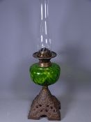 VICTORIAN OIL LAMP with iron base and green glass reservoir