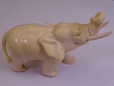 CIRCA 1900 INDIAN CARVED IVORY ELEPHANT FIGURINE, 8.25cms H, 11.5cms L (slight chipped loss to one