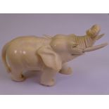 CIRCA 1900 INDIAN CARVED IVORY ELEPHANT FIGURINE, 8.25cms H, 11.5cms L (slight chipped loss to one