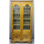 OAK BOOKCASE twin glazed and leaded upper doors, interior adjustable shelves over twin base doors