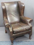 ANTIQUE STYLE BROWN LEATHER WINGBACK ARMCHAIR with foldover arms on carved knee front supports,