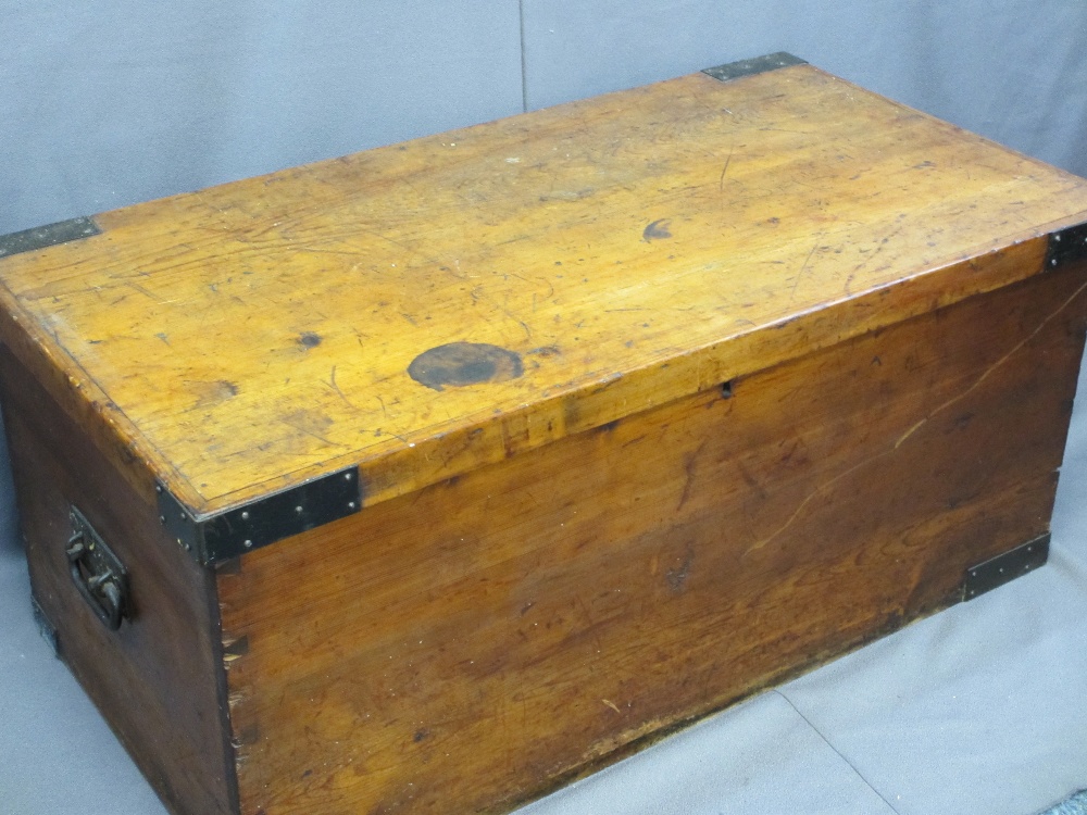 ANTIQUE PINE LIDDED STORAGE BOX with iron carry handles and corner straps, 48cms H, 110cms W,