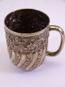 HIGHLY EMBOSSED LONDON SILVER TANKARD dated 1902 with profuse floral and ribbed decoration, 5.3 troy