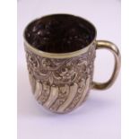 HIGHLY EMBOSSED LONDON SILVER TANKARD dated 1902 with profuse floral and ribbed decoration, 5.3 troy