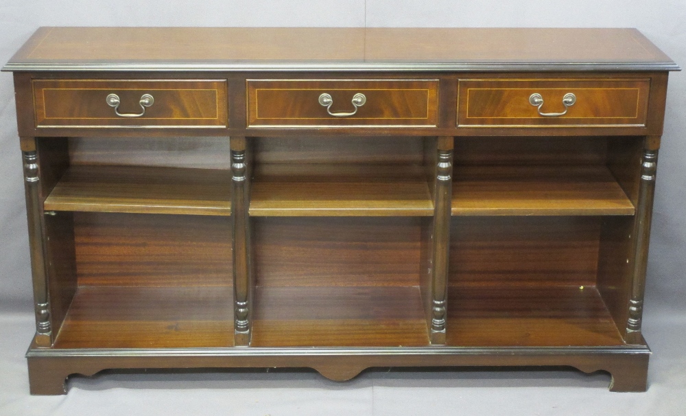 REPRODUCTION MAHOGANY BOOKCASE having three frieze drawers and a sectional base with adjustable