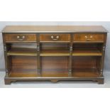 REPRODUCTION MAHOGANY BOOKCASE having three frieze drawers and a sectional base with adjustable