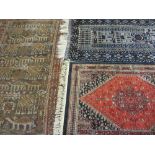 EASTERN WOOLLEN CARPETS (3) including a vintage red ground example with repeated central block