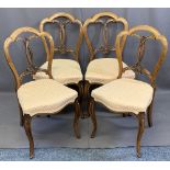 SET OF FOUR WALNUT PARLOUR CHAIRS having shaped crests and carved detail to the backs with stuff