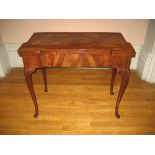 ROSEWOOD GAMES TABLE - with finely grained foldover top having a folding base on cabriole