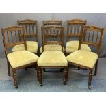 SET OF SIX EDWARDIAN OAK PARLOUR/DINING CHAIRS with carved top rail and spindle back, stuff over
