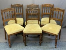 SET OF SIX EDWARDIAN OAK PARLOUR/DINING CHAIRS with carved top rail and spindle back, stuff over