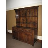 AN 18TH CENTURY OAK WELSH DRESSER, well coloured, having a twin-shelf rack with shaped ends and
