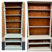 TWO GOTHIC STYLE VICTORIAN PAINTED PINE BOOKCASES having shaped canopy tops with carved