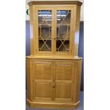 SUBSTANTIAL REPRODUCTION BLONDE OAK CORNER CABINET having a large four panel two door base and