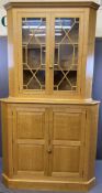 SUBSTANTIAL REPRODUCTION BLONDE OAK CORNER CABINET having a large four panel two door base and