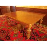 VICTORIAN OAK WIND-OUT DINING TABLE with rounded corner top and two additional slot-in leaves on