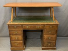 TWIN PEDESTAL DESK with a leather tooled top, two banks of four and one long central drawer and drop