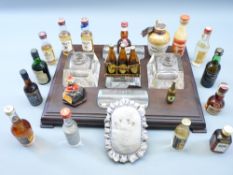 ANTIQUE DESK STAND with glass inkwells and pen holder inserts and a quantity of alcohol