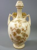 ROYAL WORCESTER BLUSH NARROW NECKED VASE of bulbous form with twin handles and floral decoration,