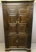 ANTIQUE OAK ONE PIECE STANDING CORNER CUPBOARD, twin upper and lower doors with chamfered panels,