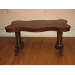 19TH CENTURY ROSEWOOD SIDE TABLE, the top of shaped and curved form with end turned pedestals with