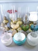 OIL LAMPS - several brass, iron based with coloured reservoirs, a quantity of etched and other