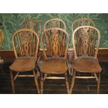 A SET OF SIX ELM WINDSOR CURVED BACK SPINDLE CHAIRS each with centre wheelback and turned supports