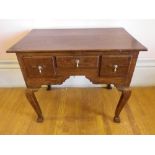 CIRCA 1820 OAK LOWBOY having two plank rectangular top over three drawers and shaped apron with