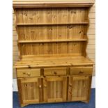 MODERN PINE DRESSER with two shelf shaped rack over a base section of three frieze drawers and