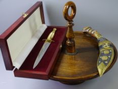 ORNAMENTAL EASTERN DAGGER, wooden cased commemorative paper opener, treen pedestal