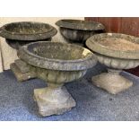 FOUR RECONSTITUTED STONE CAMPANA SHAPE GARDEN PLANTERS, 42 and 36cm heights approximately