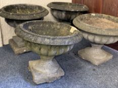 FOUR RECONSTITUTED STONE CAMPANA SHAPE GARDEN PLANTERS, 42 and 36cm heights approximately