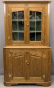 REPRODUCTION OAK TWO PIECE CORNER CUPBOARD, the twin upper doors with leaded detail to the glass and