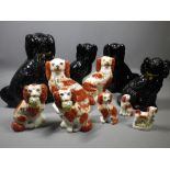 STAFFORDSHIRE POTTERY SEATED SPANIELS, a mixed group including a gilt highlighted pair of