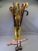 BRASS STICK STAND with assorted stick and umbrella contents and two old golf clubs