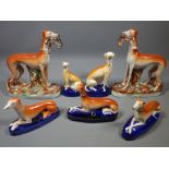 STAFFORDSHIRE POTTERY GREYHOUNDS FIGURES GROUP including a standing pair having captured hares