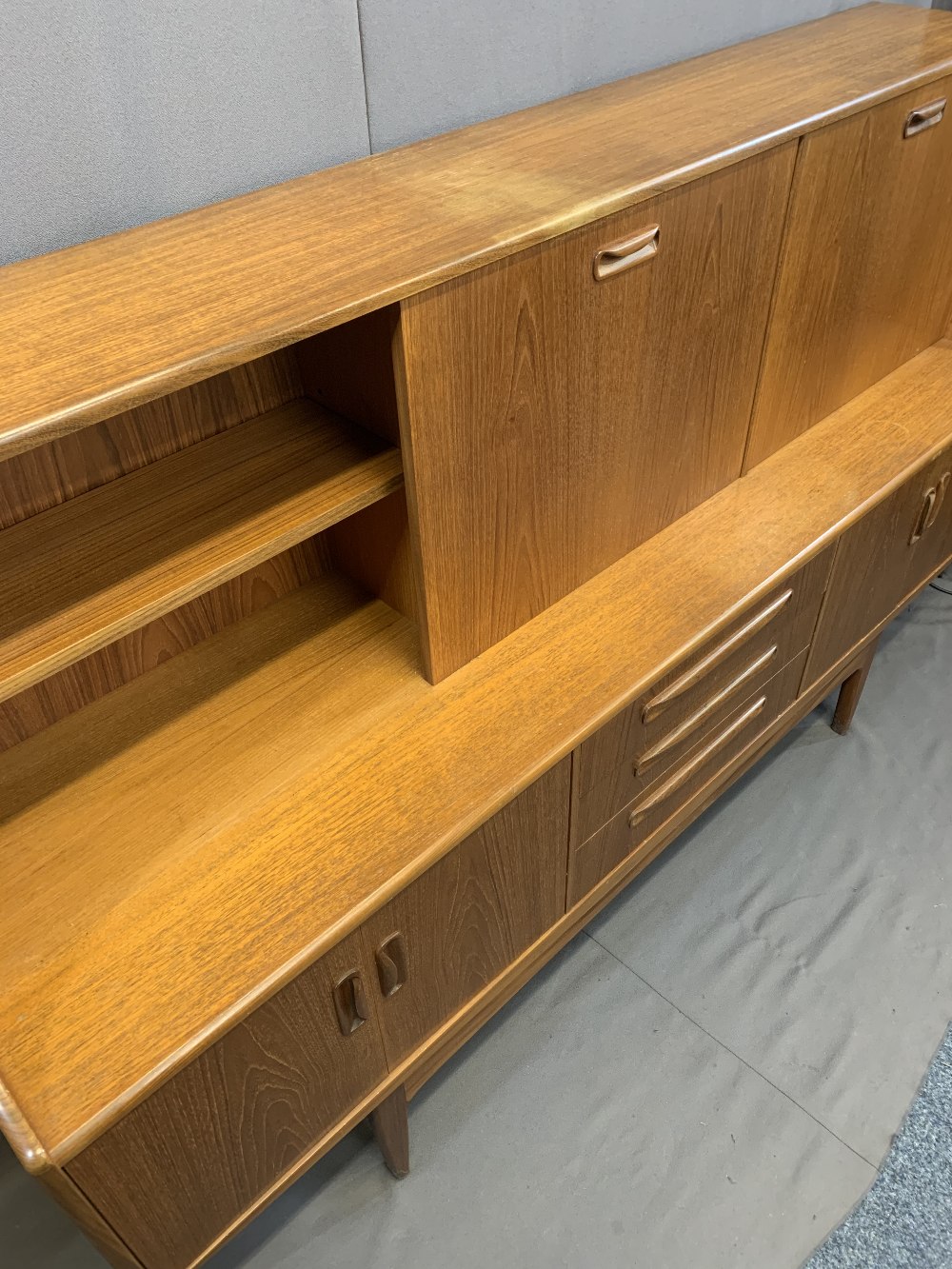 MID-CENTURY LONG TEAK SIDEBOARD with drop down top cupboards and central shelf over three central - Image 4 of 4