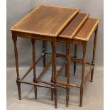 EDWARDIAN CROSSBANDED MAHOGANY NEST OF THREE SPIDER LEG OCCASIONAL TABLES, 65cms H, 56cms W, 37cms D