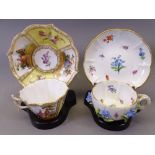 MEISEN - two cup and saucer sets, one with floral relief decoration, both on stands