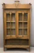 ARTS & CRAFTS PERIOD OAK BOOKCASE having a galleried top with central inlay repeated to the twin