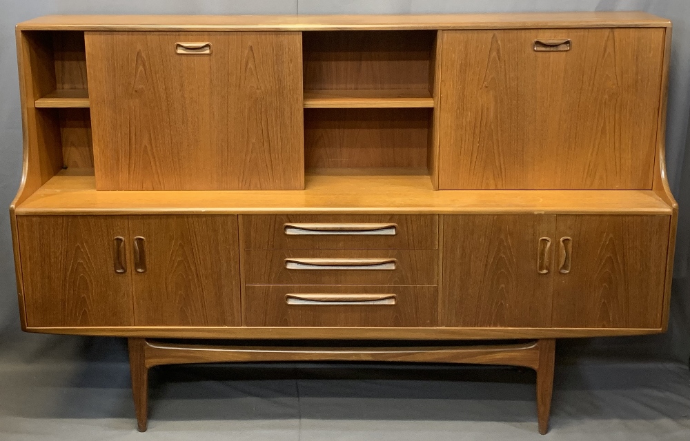 MID-CENTURY LONG TEAK SIDEBOARD with drop down top cupboards and central shelf over three central