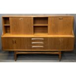 MID-CENTURY LONG TEAK SIDEBOARD with drop down top cupboards and central shelf over three central