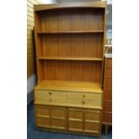 MID-CENTURY NATHAN TEAK SIDE CABINET, shelved top above base fitted four-frieze drawers and panelled