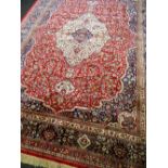 KASHMIR TABRIZ-STYLE CARPET, artificial silk, with ivory medallion and pendants on a shaped red