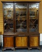 FINE WARING & GILLOW MAHOGANY BREAKFRONT BOOKCASE, foliate carved cavetto cornice above astragal