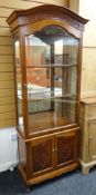 MODERN CHINESE HARDWOOD DISPLAY CABINET, carved arched top, mirror-back interior with adjustable