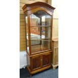 MODERN CHINESE HARDWOOD DISPLAY CABINET, carved arched top, mirror-back interior with adjustable