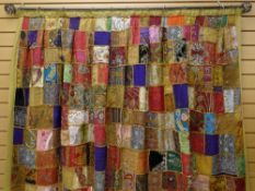 INDIAN PATCHWORK DRAPE, comprised of Rajasthani embroidered textile squares, many from wedding