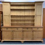 LARGE ANTIQUE PINE COUNTRY HOUSE KITCHEN DRESSER, boarded plate rack with flanking cupboards, a base