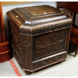 AN EARLY 20TH CENTURY CARVED OAK SQUARE CELLARETTE, hinged lid and fitted interior for bottles